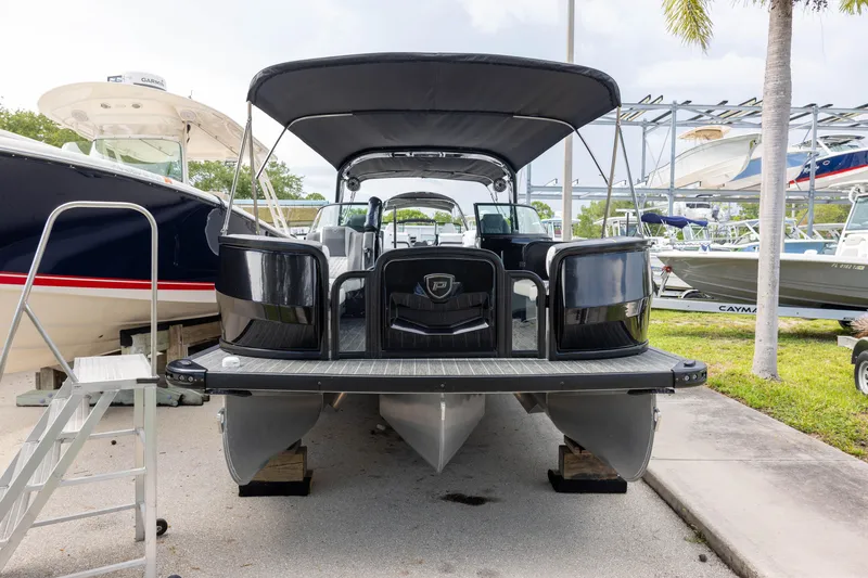 Slide: The Image of 2026 Premier 270 Intrigue GTS RF - CL pontoon boat with port gate, docked outdoors. - 3