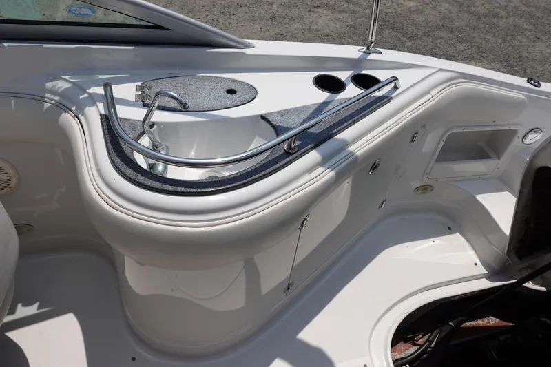 Slide: The Image of 2004 Crownline 240 EX boat interior with sink and cup holders. - 7