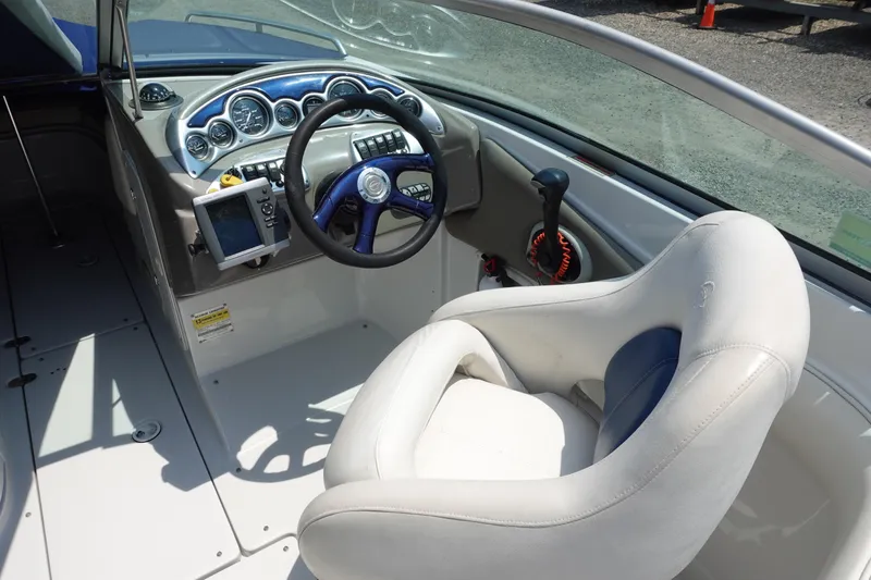 Slide: The Image of Interior of a 2004 Crownline 240 EX boat showing steering wheel and dashboard controls. - 3