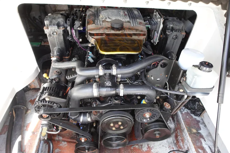 Slide: The Image of 2004 Crownline 240 EX boat engine compartment with visible components and wiring. - 11