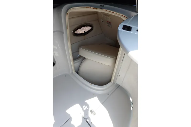 Slide: The Image of 2004 Crownline 240 EX boat interior with seating and porthole window. - 9