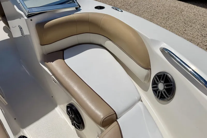 Slide: The Image of 2016 Key West 203 DFS boat interior with tan and white seating, featuring built-in speakers. - 11