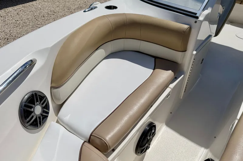 Slide: The Image of 2016 Key West 203 DFS boat interior with tan and white seating, featuring built-in speakers. - 12