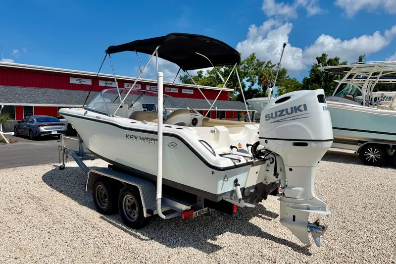 Slide: The Image of 2016 Key West 203 DFS boat with Suzuki engine on trailer, parked outdoors. - 6