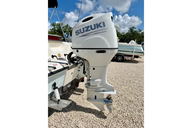 Slide: The Image of 2016 Key West 203 DFS boat with Suzuki outboard motor on gravel lot. - 34