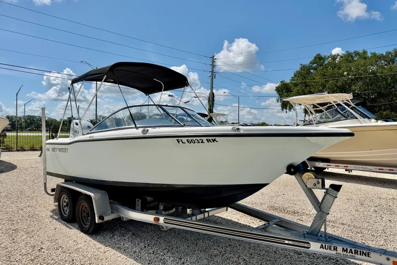 Slide: The Image of 2016 Key West 203 DFS boat on trailer under clear blue sky. - 3
