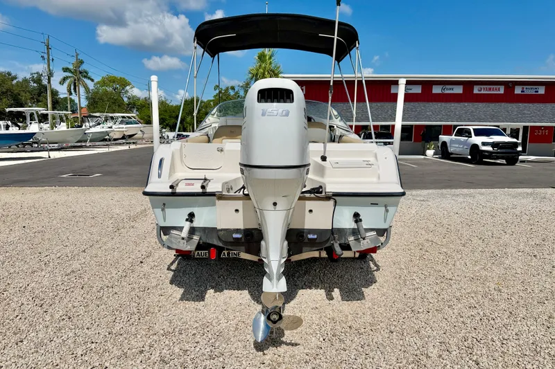 Slide: The Image of 2016 Key West 203 DFS boat with outboard motor in a dealership lot. - 5