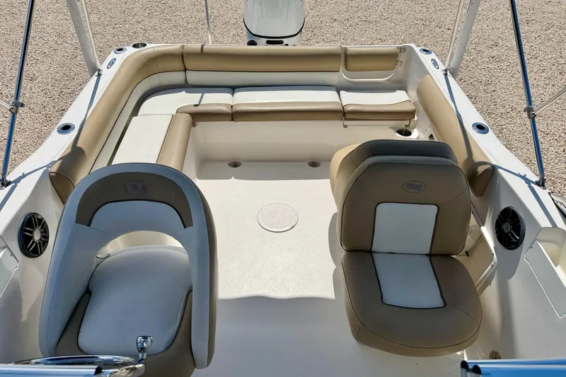 Slide: The Image of 2016 Key West 203 DFS boat interior with beige seating and steering wheel. - 13