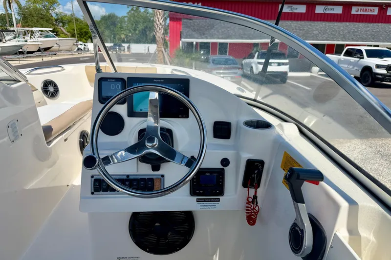 Slide: The Image of 2016 Key West 203 DFS boat dashboard with steering wheel and controls. - 16