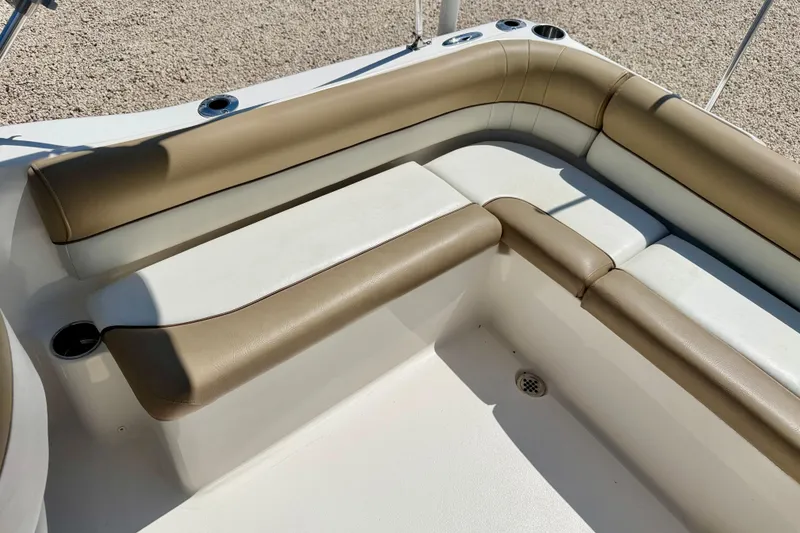 Slide: The Image of 2016 Key West 203 DFS boat interior with tan and white cushioned seating. - 24