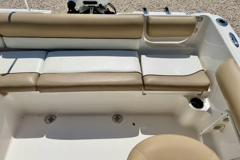 Slide: The Image of 2016 Key West 203 DFS boat interior with beige seating and cup holders. - 25