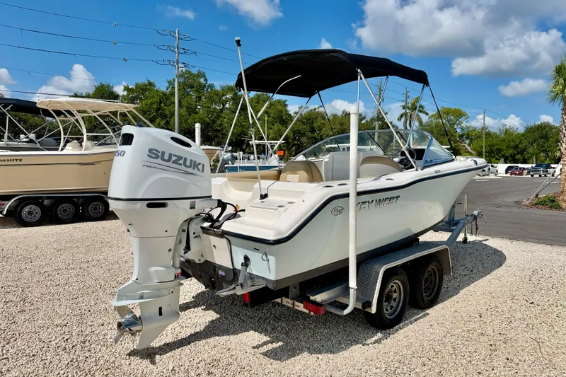 Slide: The Image of 2016 Key West 203 DFS boat with Suzuki engine on trailer, parked outdoors. - 4