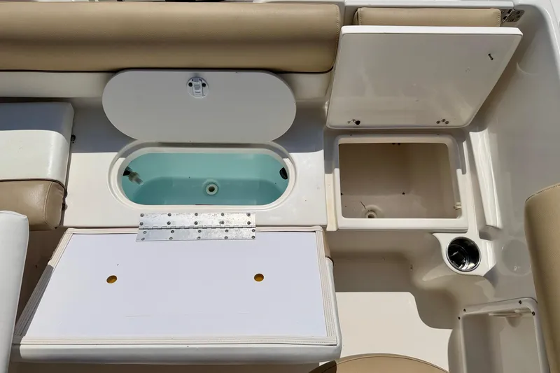 Slide: The Image of Interior view of a 2016 Key West 203 DFS boat with storage compartments and seating. - 29