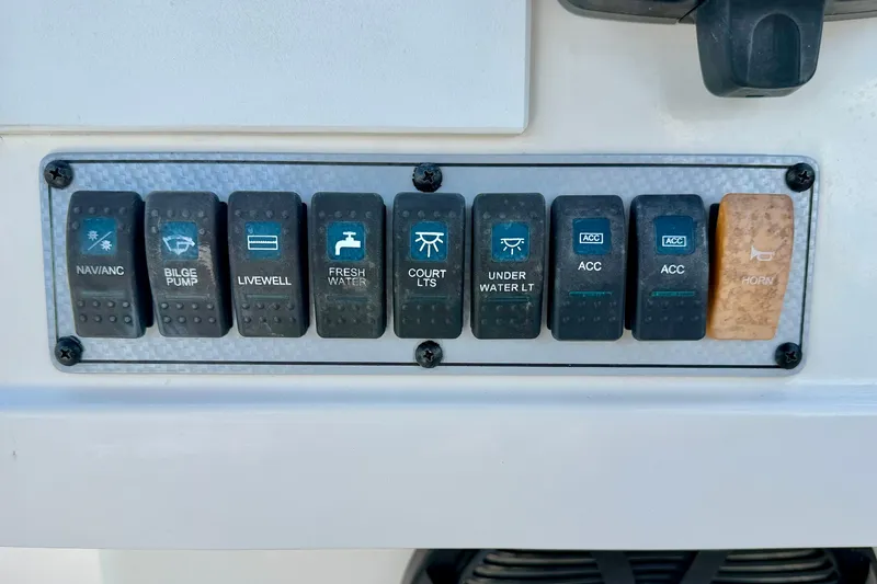 Slide: The Image of Control panel of a 2016 Key West 203 DFS boat with labeled switches. - 21