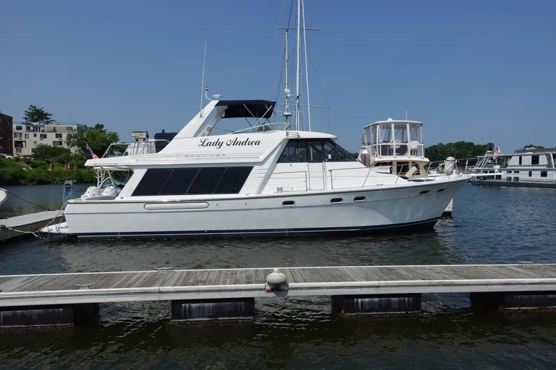 Slide: The Image of 2000 Bayliner 4788 Pilot House Motoryacht docked at marina on a sunny day. - 4