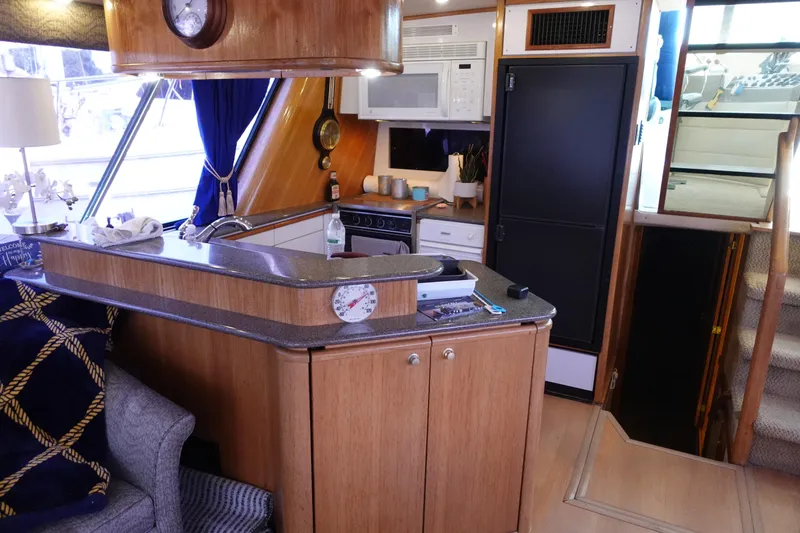 Slide: The Image of Interior of 2000 Bayliner 4788 Pilot House Motoryacht with kitchen and stairs. - 31
