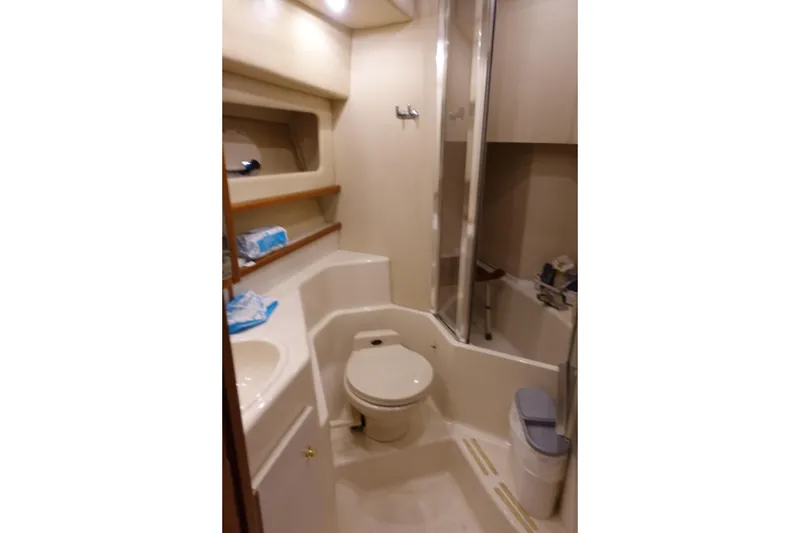 Slide: The Image of Bathroom interior of 2000 Bayliner 4788 Pilot House Motoryacht, featuring toilet and shower. - 26