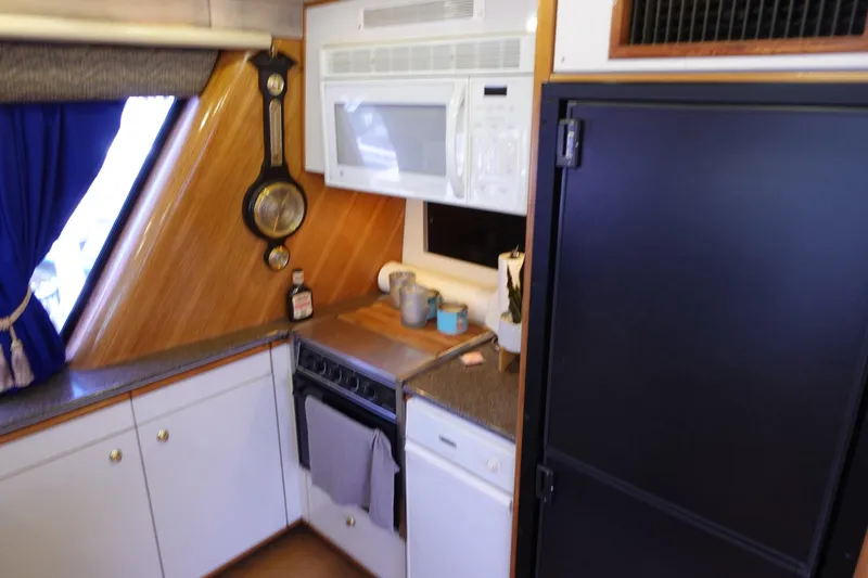 Slide: The Image of Galley kitchen in 2000 Bayliner 4788 Pilot House Motoryacht with microwave and stove. - 28