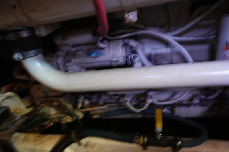 Slide: The Image of Engine compartment of a 2000 Bayliner 4788 Pilot House Motoryacht, showing pipes and wiring. - 34