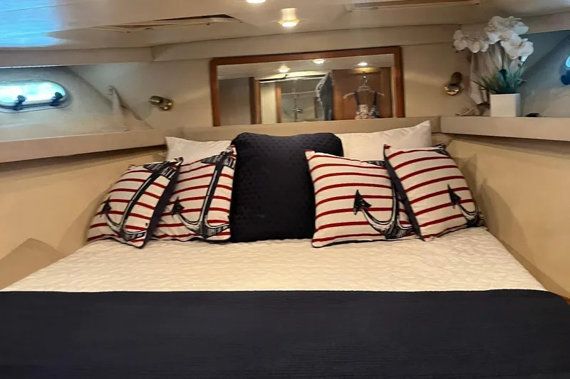 Slide: The Image of Cozy bedroom in 2000 Bayliner 4788 Pilot House Motoryacht with nautical-themed pillows. - 20