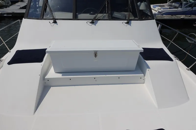 Slide: The Image of 2000 Bayliner 4788 Pilot House Motoryacht deck with storage box and seating. - 7