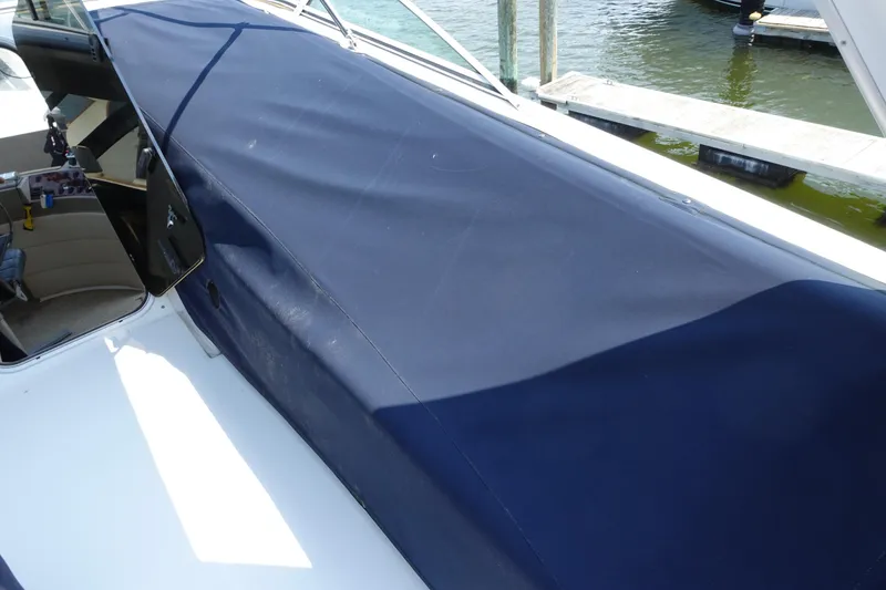 Slide: The Image of 2000 Bayliner 4788 Pilot House Motoryacht with blue cover at dockside. - 16