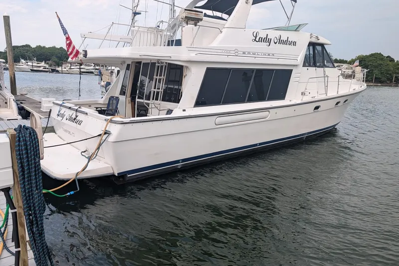 Slide: The Image of 2000 Bayliner 4788 Pilot House Motoryacht docked at marina, named "Lady Andrea". - 4
