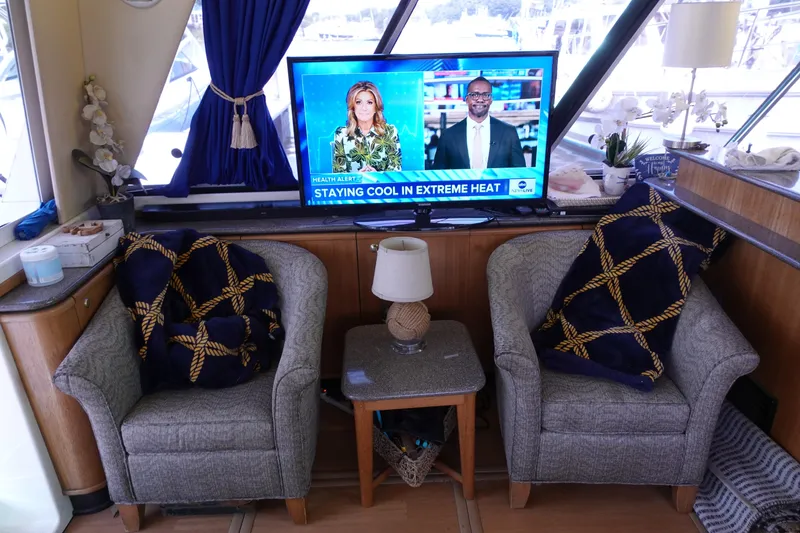 Slide: The Image of Interior of 2000 Bayliner 4788 Pilot House Motoryacht with TV and cozy seating area. - 30