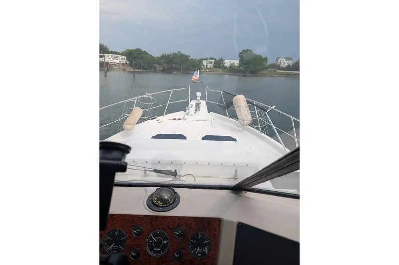 Slide: The Image of 2000 Bayliner 4788 Pilot House Motoryacht navigating calm waters, view from helm. - 6