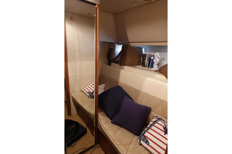 Slide: The Image of Interior of 2000 Bayliner 4788 Pilot House Motoryacht with cozy seating and decorative pillows. - 24