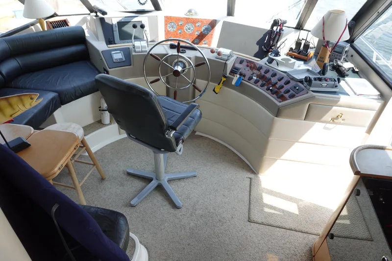 Slide: The Image of Pilot house interior of 2000 Bayliner 4788 Motoryacht with steering wheel and control panel. - 17
