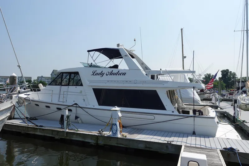 Slide: The Image of 2000 Bayliner 4788 Pilot House Motoryacht docked at marina, side view. - 1