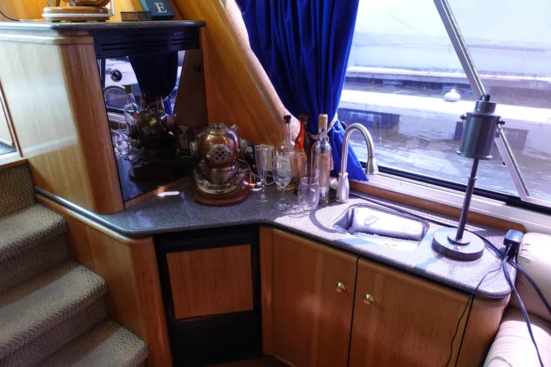 Slide: The Image of Interior of 2000 Bayliner 4788 Pilot House Motoryacht with bar area and nautical decor. - 29