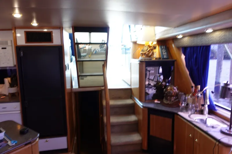 Slide: The Image of Interior of 2000 Bayliner 4788 Pilot House Motoryacht with stairs and kitchenette. - 32