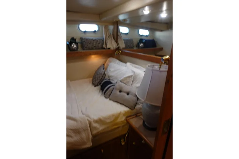 Slide: The Image of Cozy bedroom in 2000 Bayliner 4788 Pilot House Motoryacht with plush pillows and soft lighting. - 23