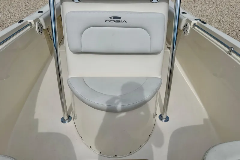 Slide: The Image of 2020 Cobia 237 Center Console boat seating area with stainless steel railings. - 13