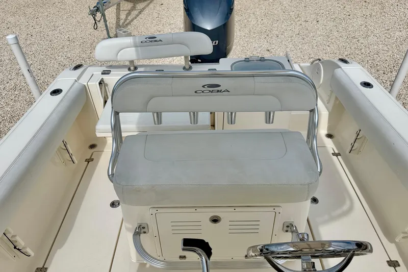 Slide: The Image of 2020 Cobia 237 Center Console boat interior with seating and steering wheel. - 16