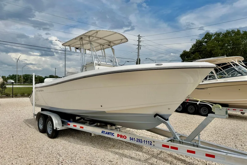 Slide: The Image of 2020 Cobia 237 Center Console boat on trailer under cloudy sky. - 3