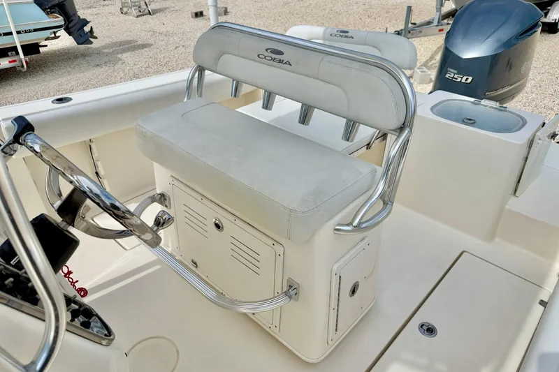 Slide: The Image of 2020 Cobia 237 Center Console boat interior with helm seat and steering wheel. - 14