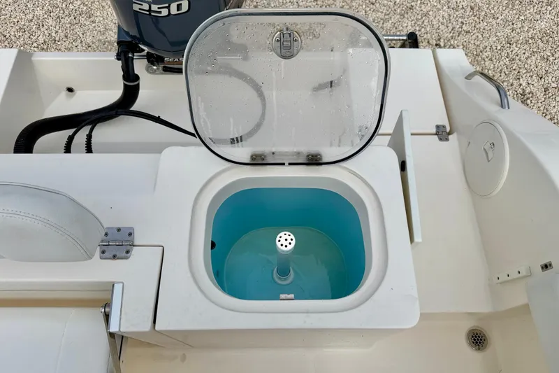 Slide: The Image of 2020 Cobia 237 Center Console boat with open livewell and Yamaha 250 engine. - 32