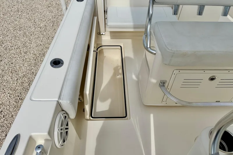 Slide: The Image of 2020 Cobia 237 Center Console boat interior with seating and storage compartment. - 31