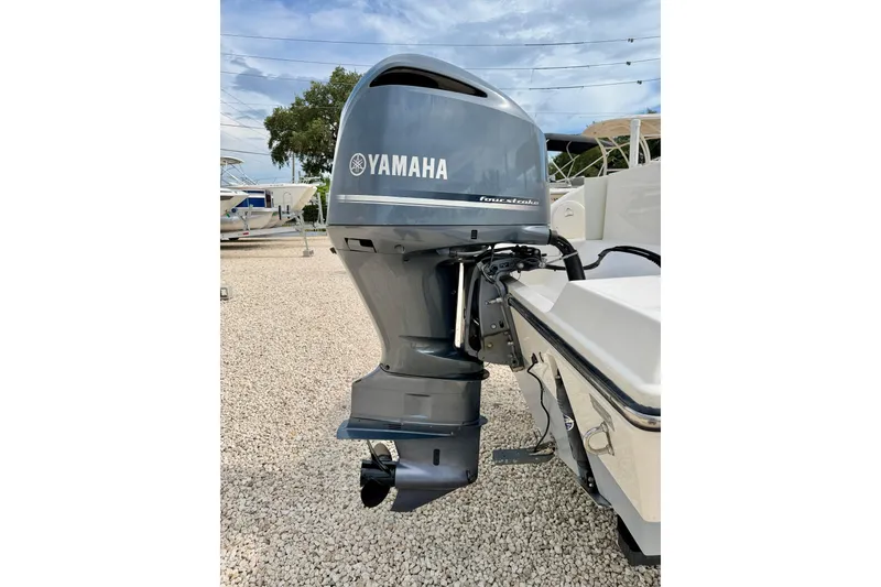 Slide: The Image of Yamaha outboard motor on 2020 Cobia 237 Center Console boat, parked on gravel. - 34