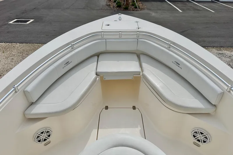 Slide: The Image of 2020 Cobia 237 Center Console boat with cushioned seating and stainless steel railings. - 8