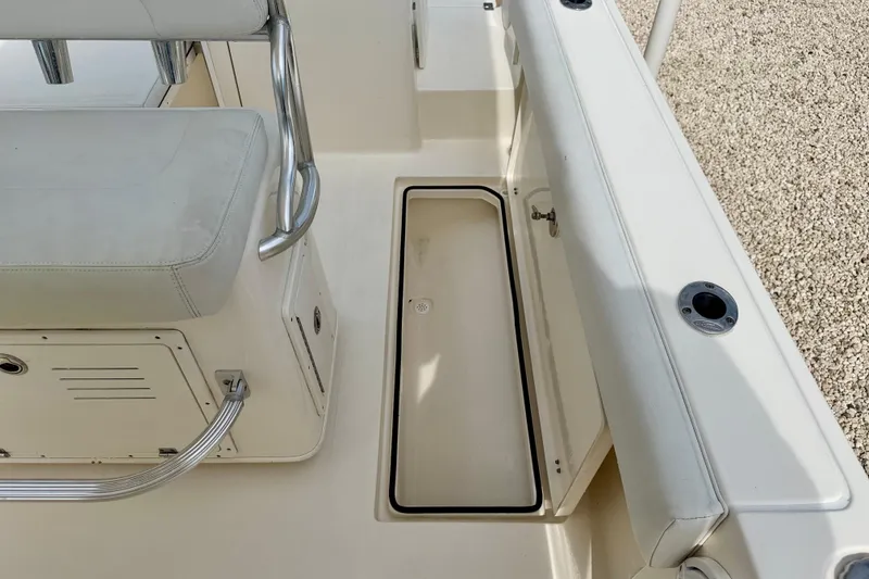 Slide: The Image of 2020 Cobia 237 Center Console boat interior with seating and storage compartment. - 30