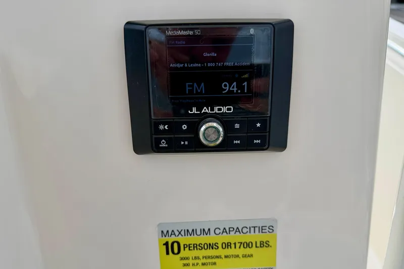 Slide: The Image of JL Audio MediaMaster 50 on 2020 Cobia 237 Center Console, FM 94.1, 10-person capacity. - 22