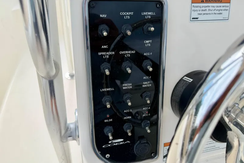 Slide: The Image of Control panel of a 2020 Cobia 237 Center Console boat with labeled switches. - 19