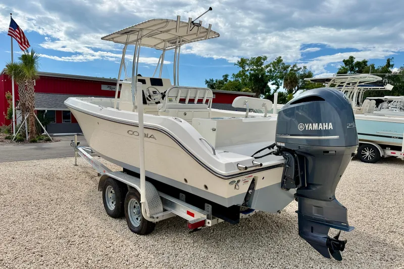 Slide: The Image of 2020 Cobia 237 Center Console boat with Yamaha engine on trailer, parked outdoors. - 7