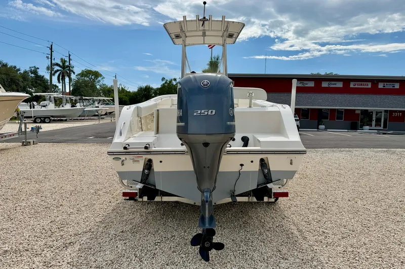 Slide: The Image of 2020 Cobia 237 Center Console boat with Yamaha 250 engine, parked on gravel lot. - 6