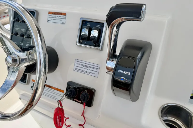 Slide: The Image of Control panel of 2020 Cobia 237 Center Console with Yamaha throttle and steering wheel. - 23