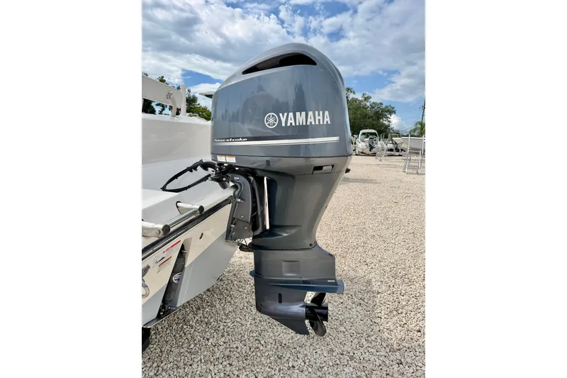 Slide: The Image of 2020 Cobia 237 Center Console with Yamaha outboard motor on gravel lot. - 36